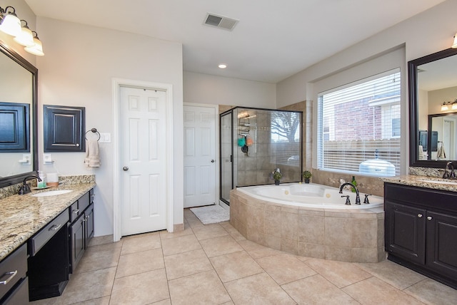 bathroom featuring a garden tub, visible vents, a sink, and a stall shower