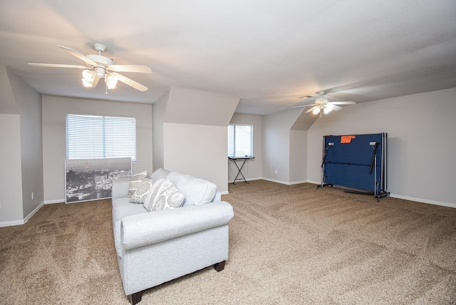living area with carpet flooring, baseboards, and ceiling fan