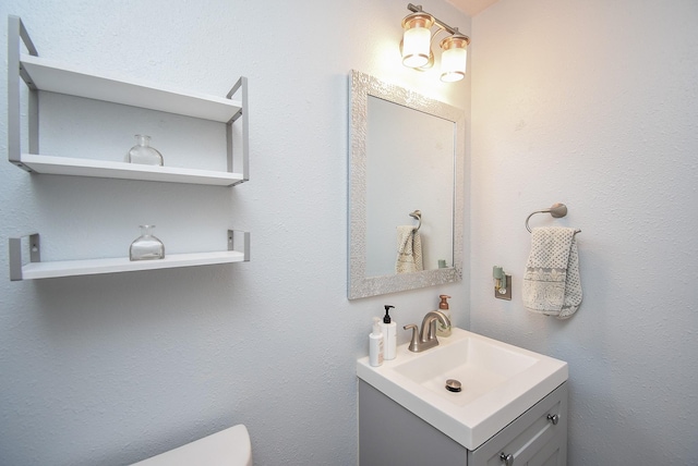 bathroom featuring toilet and vanity