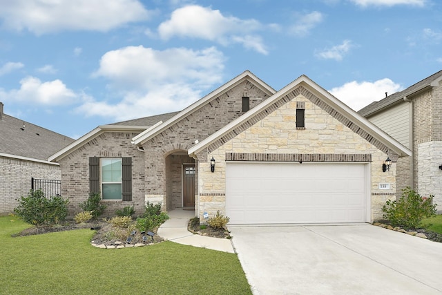 french country inspired facade with driveway, roof with shingles, a front lawn, a garage, and brick siding