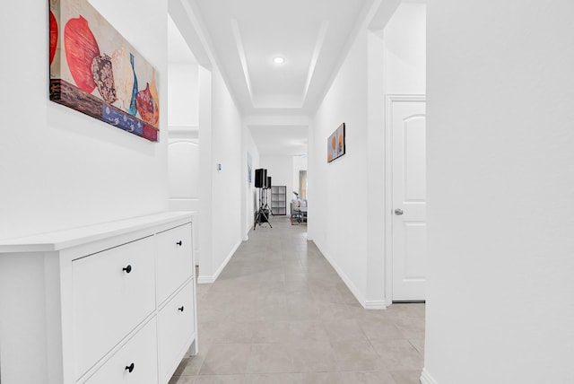 corridor featuring recessed lighting, baseboards, and light tile patterned flooring