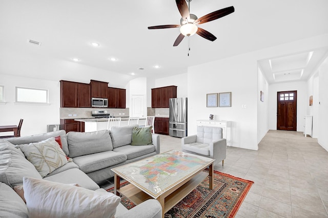 living room with a ceiling fan, light tile patterned floors, recessed lighting, and visible vents