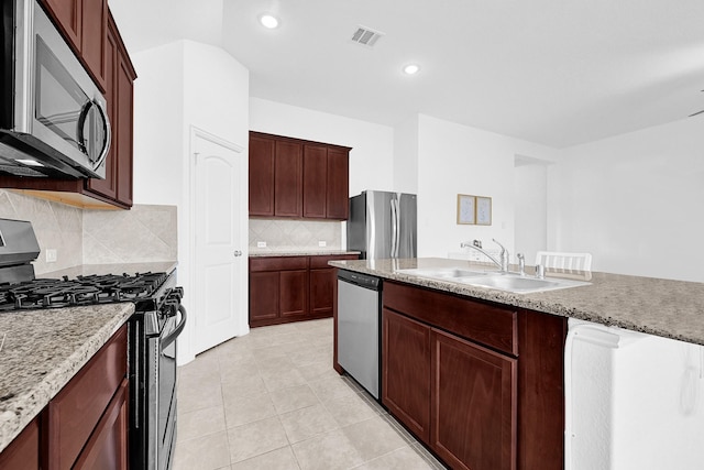 kitchen featuring light tile patterned floors, visible vents, a sink, decorative backsplash, and stainless steel appliances