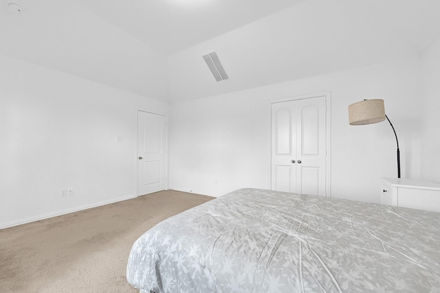 carpeted bedroom featuring visible vents, baseboards, and vaulted ceiling