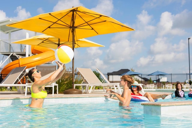 community pool with a water play area and a water slide