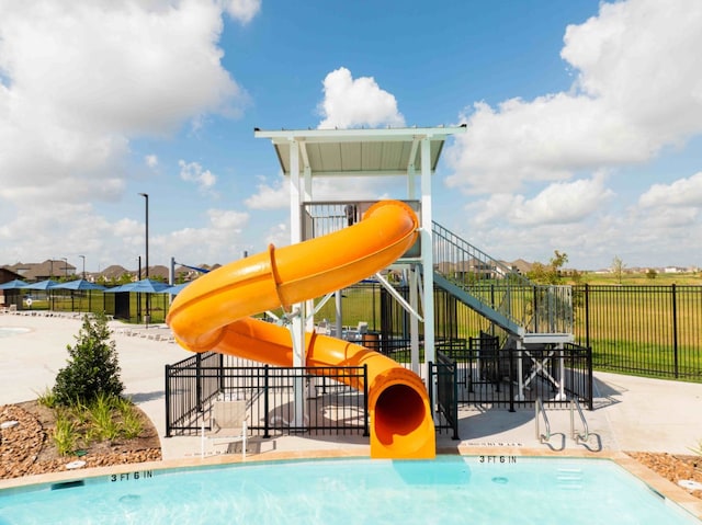 community jungle gym with a water play area and fence