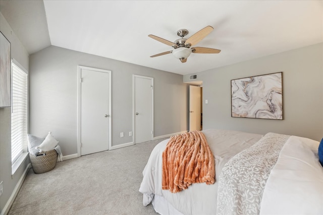 bedroom with visible vents, baseboards, lofted ceiling, ceiling fan, and carpet