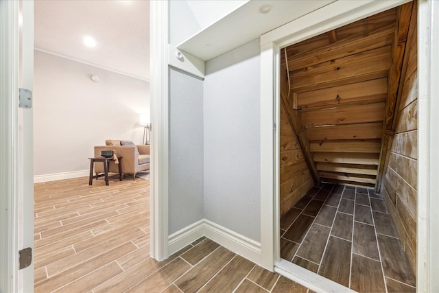 hallway featuring wood tiled floor and baseboards