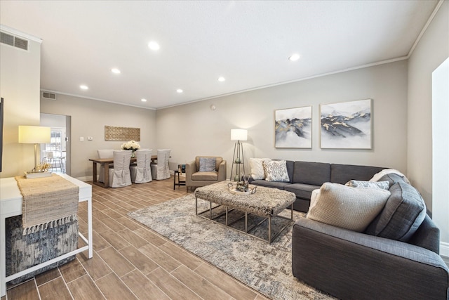 living area featuring ornamental molding, wood finish floors, visible vents, and recessed lighting