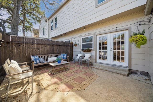 view of patio with entry steps, fence, an outdoor hangout area, and french doors