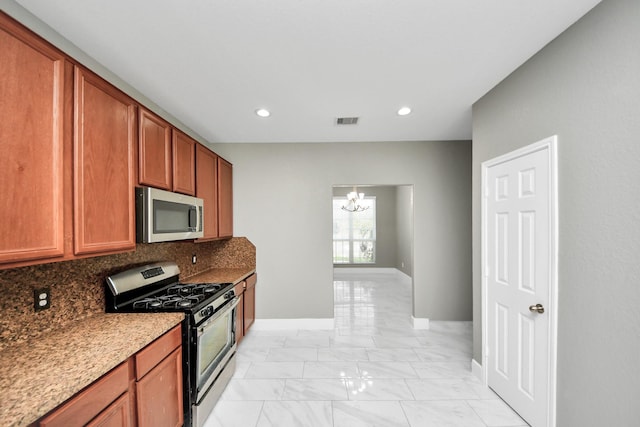 kitchen featuring visible vents, appliances with stainless steel finishes, marble finish floor, a chandelier, and backsplash