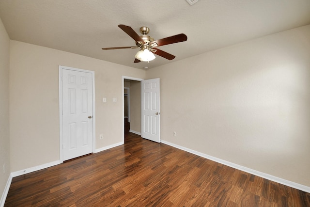 unfurnished bedroom with wood finished floors, a ceiling fan, and baseboards