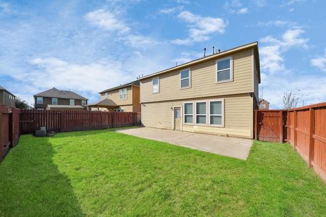 rear view of house with a patio area, a lawn, and a fenced backyard