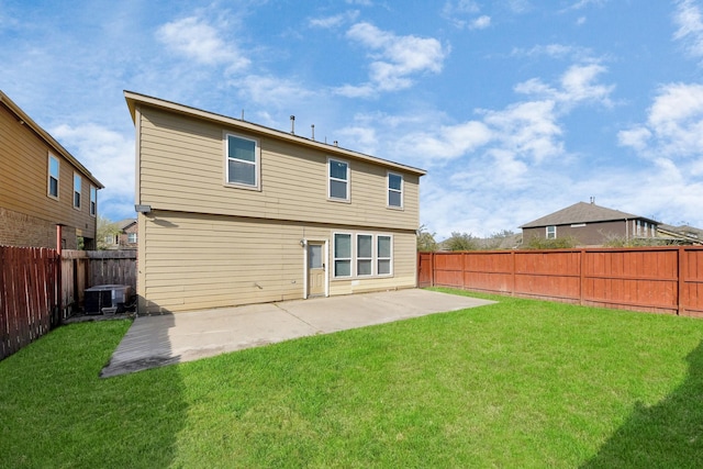 rear view of house with a patio area, a fenced backyard, a lawn, and central AC unit