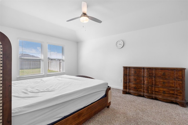 bedroom featuring carpet floors, baseboards, vaulted ceiling, and a ceiling fan