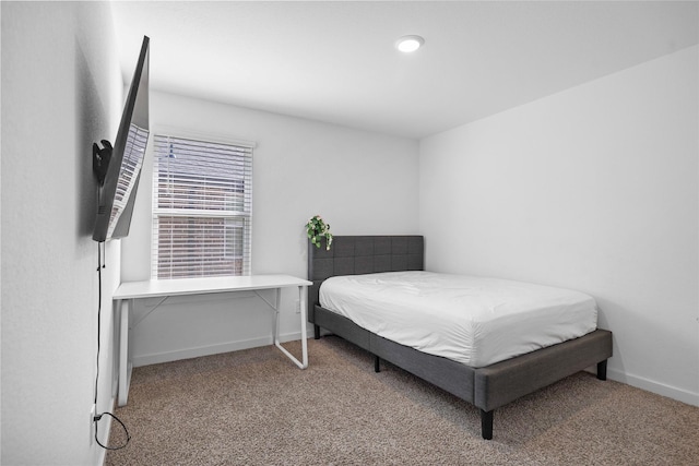 carpeted bedroom featuring baseboards