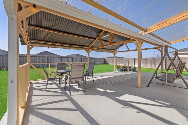 view of patio / terrace with a gazebo, a fenced backyard, and outdoor dining space