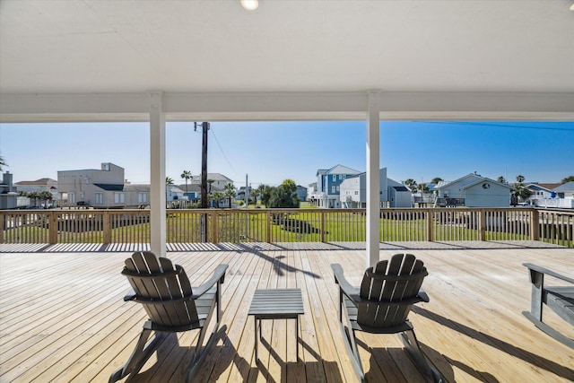 wooden deck with a lawn and a residential view