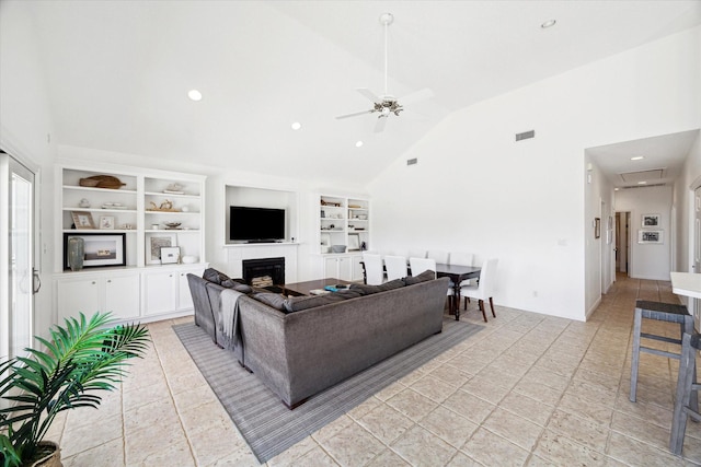 living area with built in shelves, a fireplace, visible vents, ceiling fan, and high vaulted ceiling