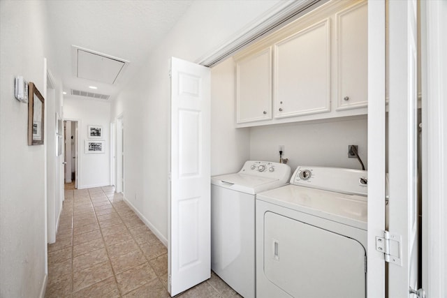 clothes washing area with separate washer and dryer, visible vents, baseboards, cabinet space, and attic access