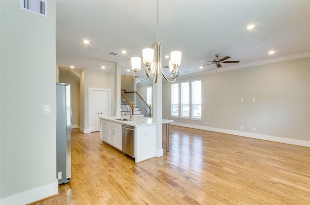 kitchen featuring stainless steel appliances, light wood-style flooring, light countertops, and visible vents