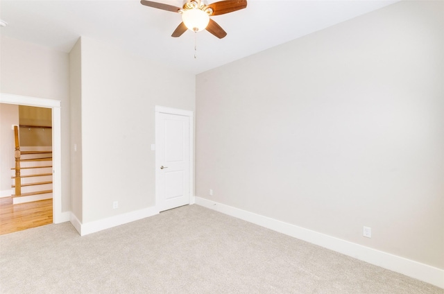 unfurnished bedroom featuring baseboards, ceiling fan, and light colored carpet