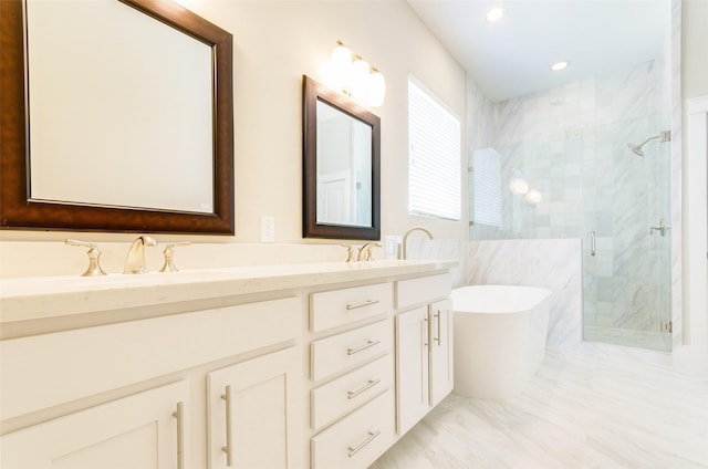 bathroom with double vanity, recessed lighting, a soaking tub, a sink, and a shower stall