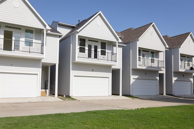 view of property featuring an attached garage and a balcony