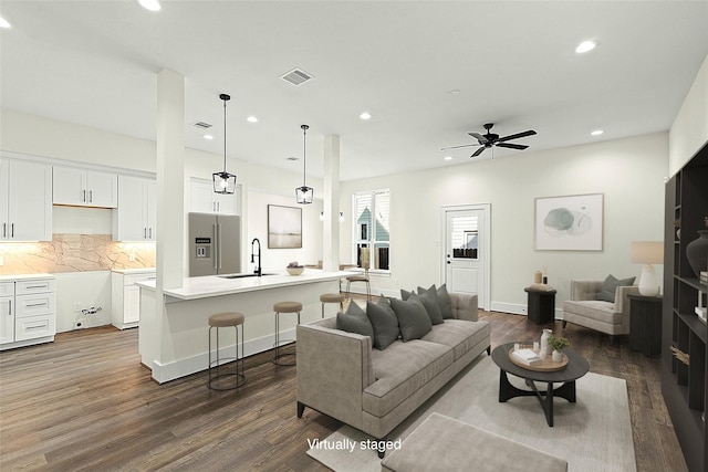 1807 Palmetto Landing Dr, Houston, TX 77009 - living room with dark wood-style flooring, recessed lighting, ceiling fan, and baseboards