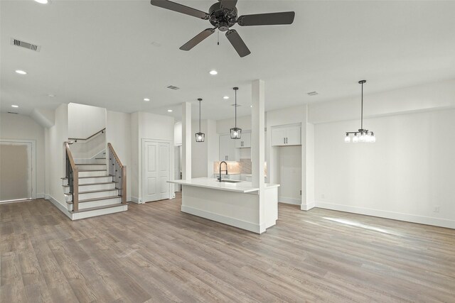 1807 Palmetto Landing Dr, Houston, TX 77009 - unfurnished living room with light wood-type flooring, ceiling fan, a sink, recessed lighting, and baseboards
