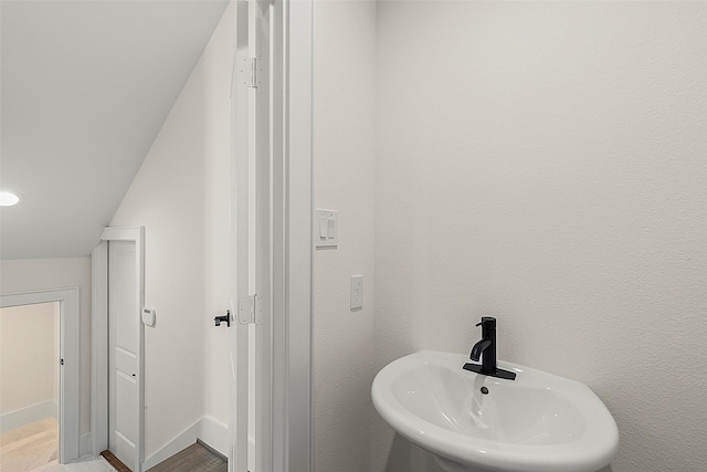 1807 Palmetto Landing Dr, Houston, TX 77009 - bathroom featuring a sink, wood finished floors, and baseboards