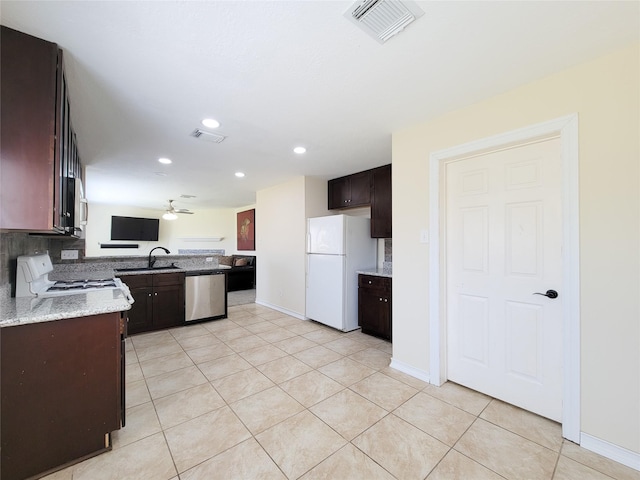 kitchen with stainless steel appliances, visible vents, dark brown cabinets, and light tile patterned floors