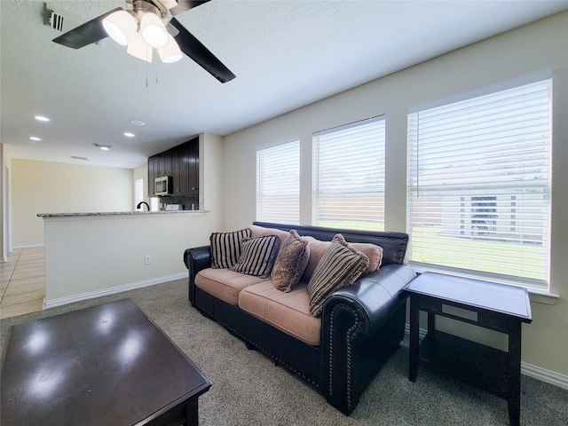 living room with recessed lighting, visible vents, a ceiling fan, a textured ceiling, and baseboards