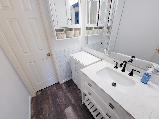 bathroom with vanity, tile walls, and wood finished floors