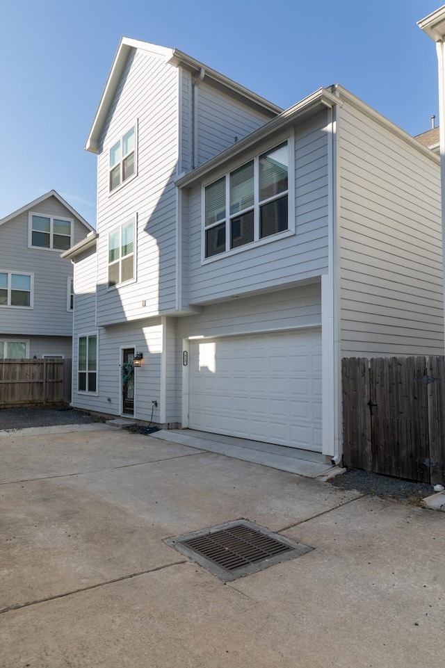 exterior space featuring fence, driveway, and an attached garage