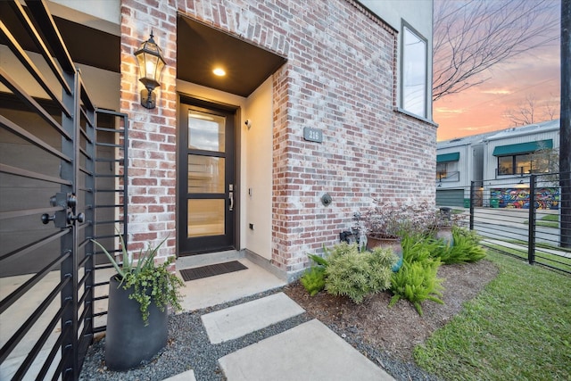 property entrance featuring brick siding