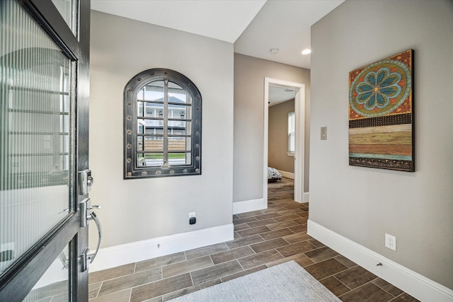 interior space featuring baseboards and wood tiled floor