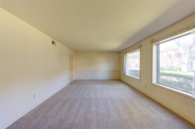 spare room featuring carpet floors and visible vents