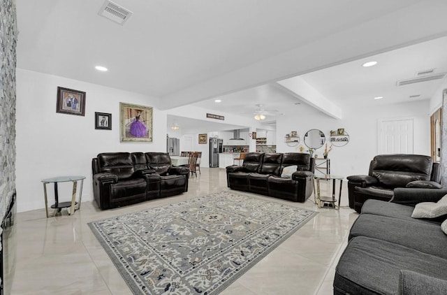 living area with a ceiling fan, recessed lighting, visible vents, and beamed ceiling