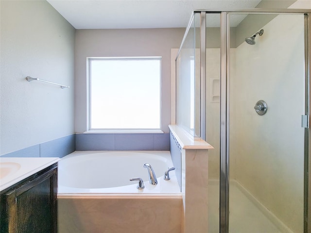 full bath featuring vanity, a shower stall, and a bath