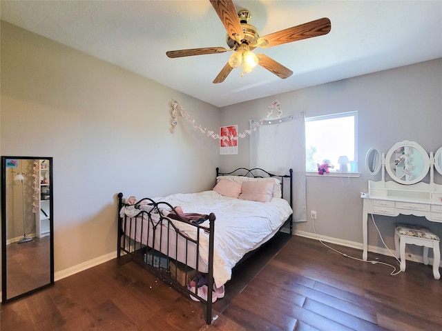 bedroom featuring a ceiling fan, baseboards, and wood finished floors