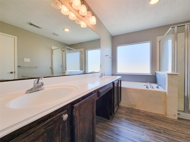 full bath with double vanity, a stall shower, and a sink