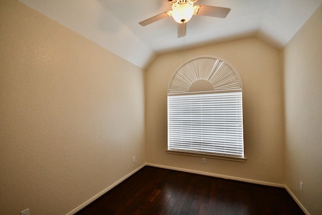 unfurnished room with lofted ceiling, baseboards, hardwood / wood-style flooring, and a ceiling fan