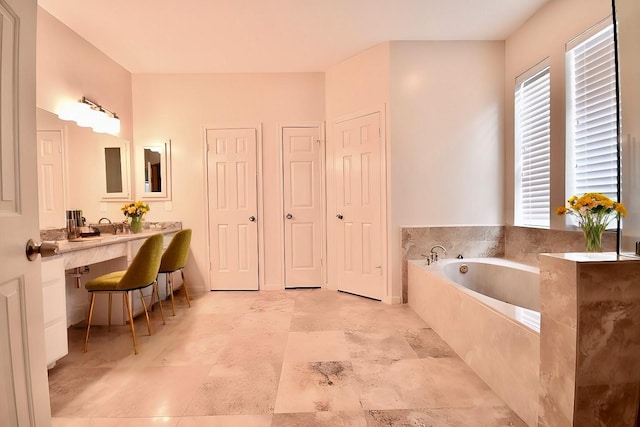 bathroom with a bath and vanity