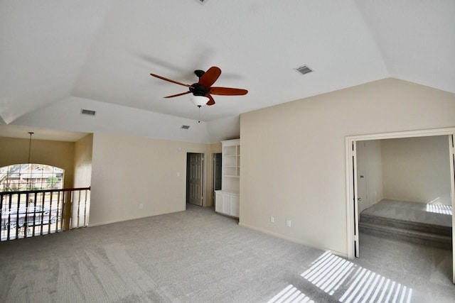 unfurnished bedroom with vaulted ceiling, visible vents, and light colored carpet