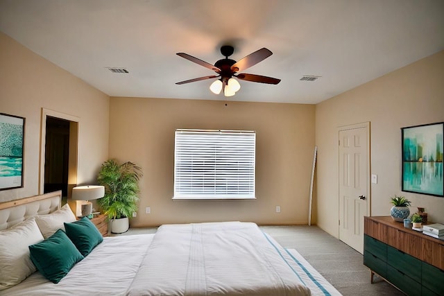 bedroom with ceiling fan, visible vents, and carpet flooring