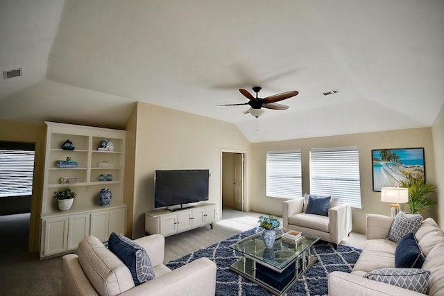 living area featuring lofted ceiling, ceiling fan, and visible vents