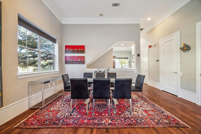 dining space featuring baseboards, visible vents, wood finished floors, crown molding, and recessed lighting