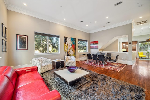 living area with recessed lighting, visible vents, ornamental molding, wood finished floors, and baseboards