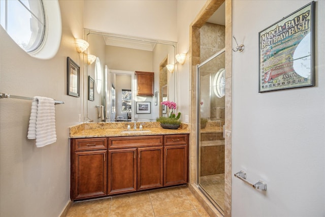 bathroom featuring a stall shower, tile patterned flooring, ornamental molding, and vanity